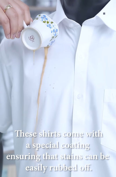 A Man wearing Minister White's Anti Stain Regular Fit shirt giving the demo of Anti stain shirt by pouring coffee on shirt and wiping the stain out